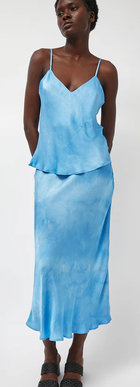 A woman wearing Les Coyotes de Paris fluid skirt in maya blue tie dye