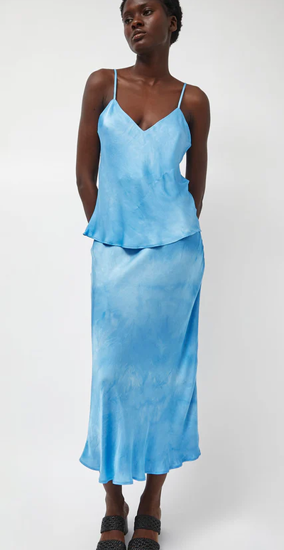 A woman wearing Les Coyotes de Paris fluid skirt in maya blue tie dye