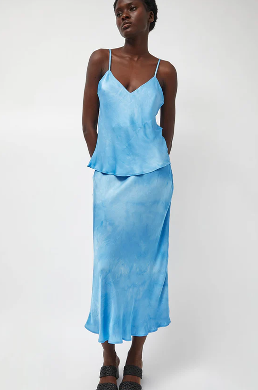 A woman wearing Les Coyotes de Paris fluid skirt in maya blue tie dye