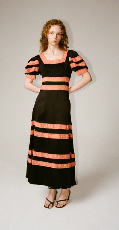A woman wearing Shrimps cressida dress - black/melon