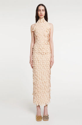 A woman wearing A.W.A.K.E. Mode multi rectangle high neck midi dress light beige