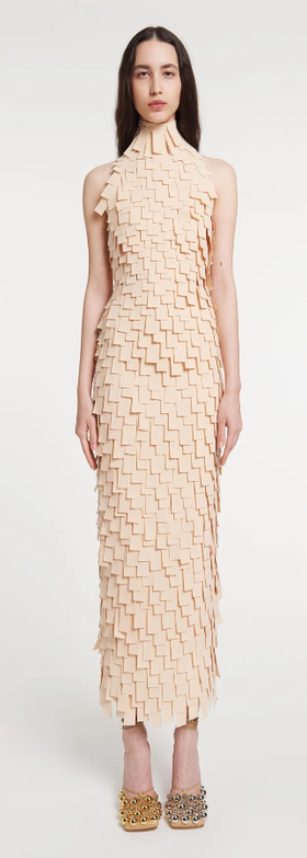 A woman wearing A.W.A.K.E. Mode multi rectangle high neck midi dress light beige