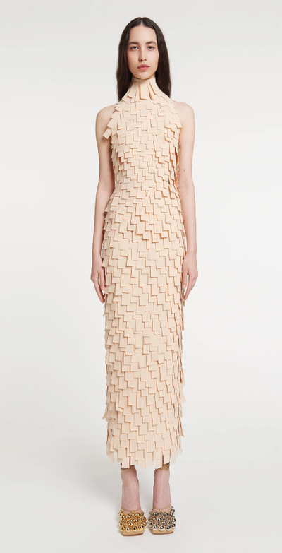 A woman wearing A.W.A.K.E. Mode multi rectangle high neck midi dress light beige