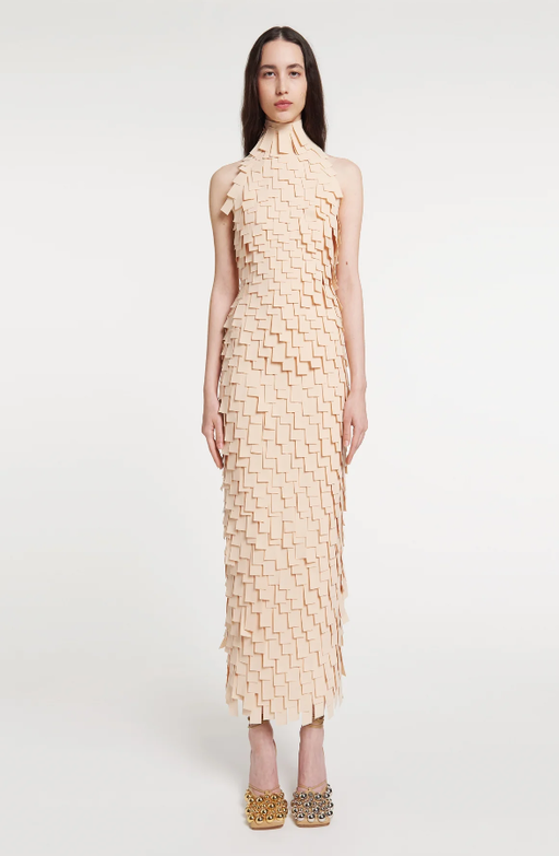 A woman wearing A.W.A.K.E. Mode multi rectangle high neck midi dress light beige