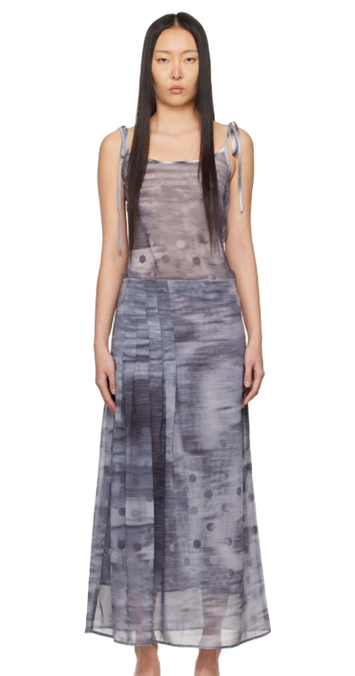 A woman wearing ELLISS gray pleated maxi dress