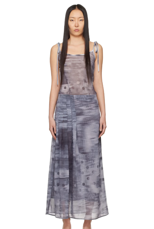 A woman wearing ELLISS gray pleated maxi dress
