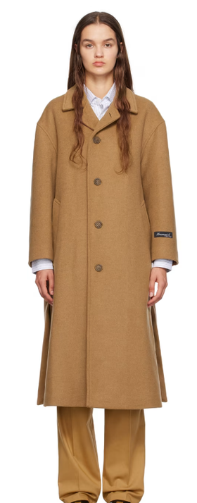 A woman wearing HommeGirls tan spread collar coat