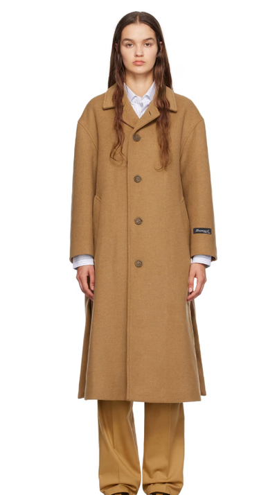 A woman wearing HommeGirls tan spread collar coat