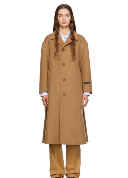 A woman wearing HommeGirls tan spread collar coat