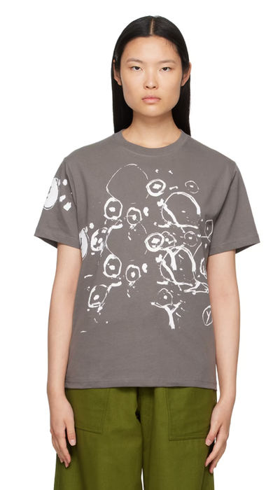 A woman wearing Gentle Fullness gray graphic t-shirt