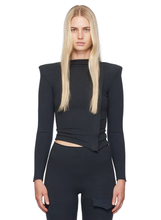 A woman wearing Greg Ross  ssense exclusive black zip top
