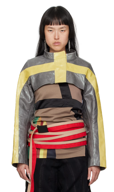 A woman wearing DIANA STRÄNG gray & yellow cropped leather jacket