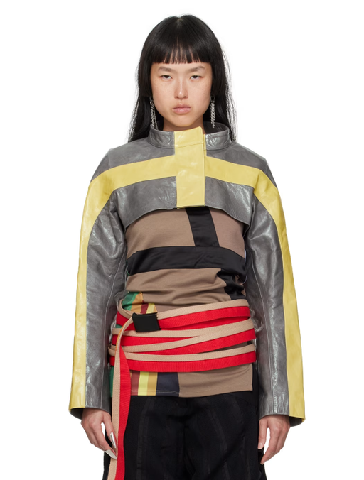 A woman wearing DIANA STRÄNG gray & yellow cropped leather jacket