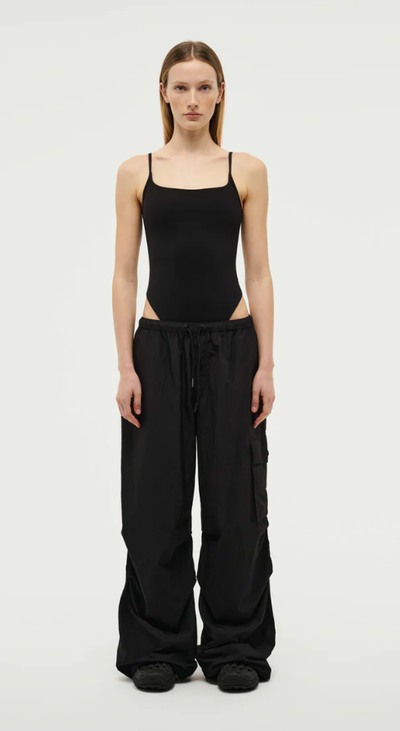 A woman wearing P.E Nation preview bodysuit in black
