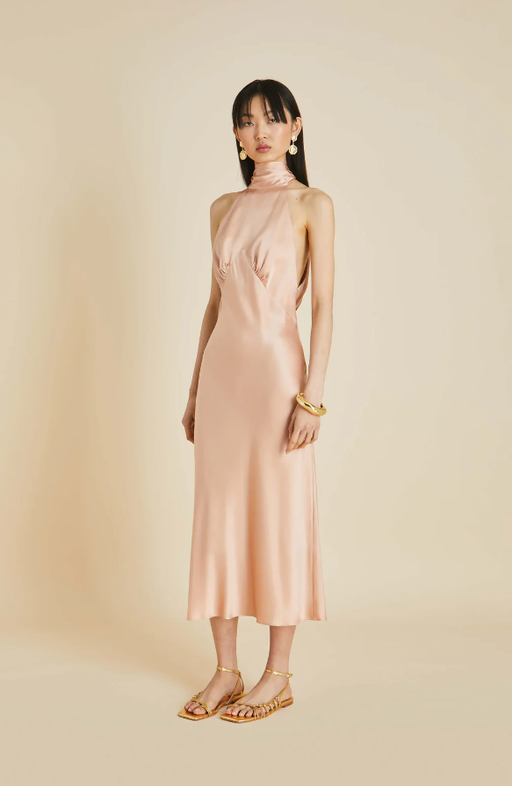 A woman wearing Olivia von Halle pink greta shell pink halterneck dress