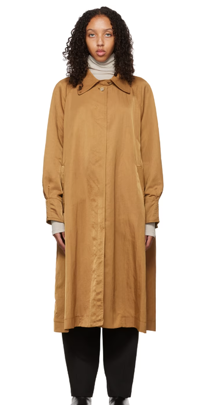 A woman wearing DEVEAUX NEW YORK tan buttoned trench coat