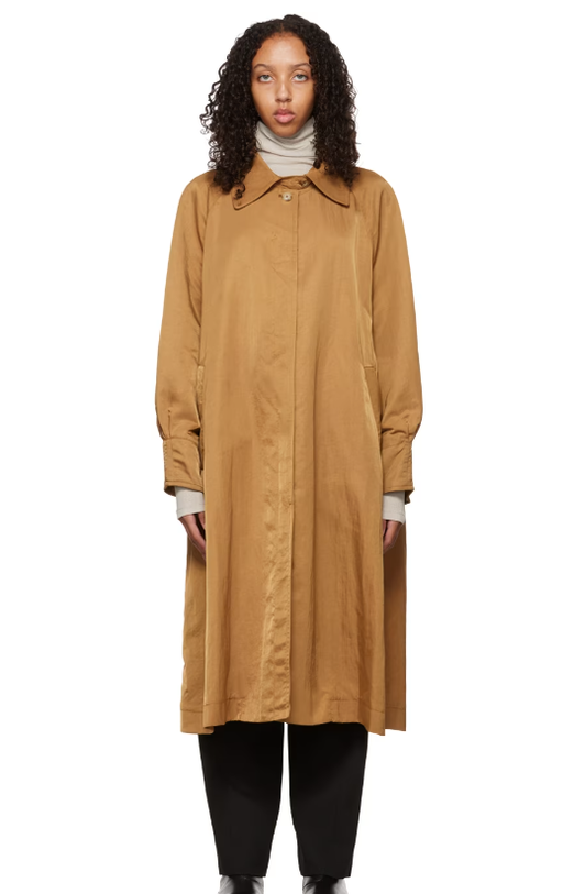 A woman wearing DEVEAUX NEW YORK tan buttoned trench coat