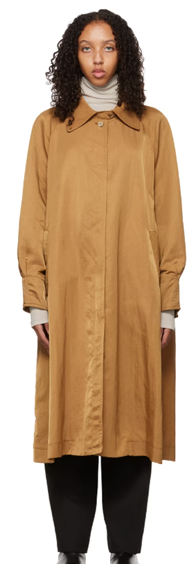 A woman wearing DEVEAUX NEW YORK tan buttoned trench coat