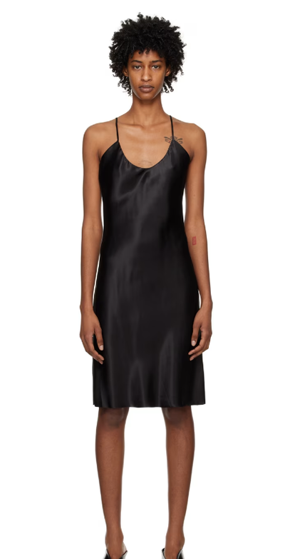 A woman wearing GIA STUDIOS black v-neck minidress
