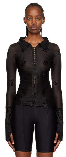A woman wearing DIDU black monogram shirt