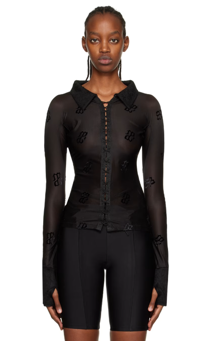 A woman wearing DIDU black monogram shirt