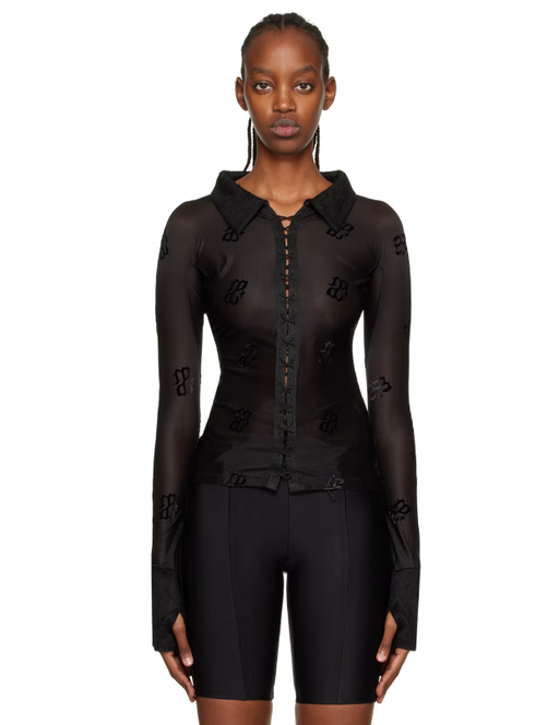 A woman wearing DIDU black monogram shirt