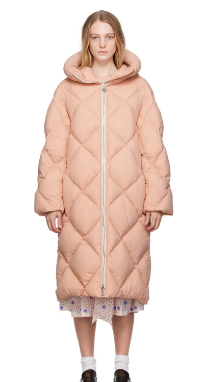 A woman wearing Ienki Ienki pink rowena down coat