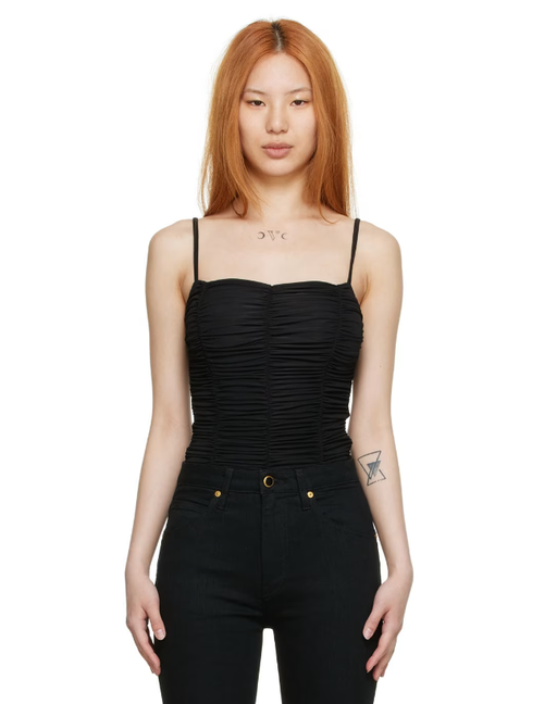 A woman wearing Goldsign black nylon bodysuit