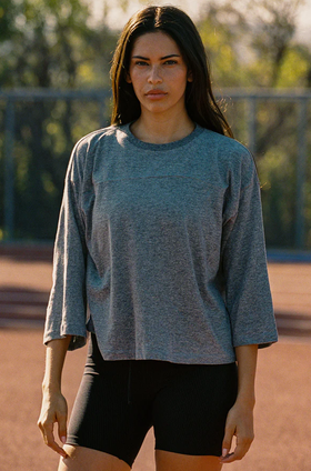 A woman wearing Year of Ours heather grey sunday tee