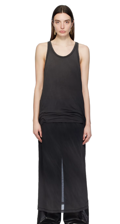 A woman wearing doublet black layered maxi dress