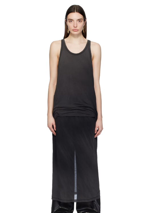A woman wearing doublet black layered maxi dress