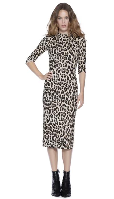 A woman wearing Alice + Olivia delora fitted mock neck midi dress