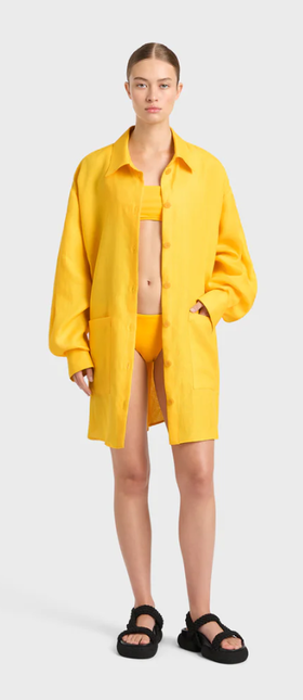 A woman wearing BONDI BORN delphi oversize shirt dress - daffodil