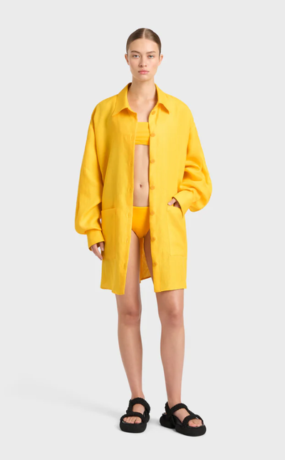 A woman wearing BONDI BORN delphi oversize shirt dress - daffodil