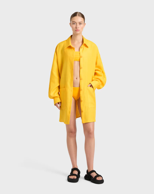 A woman wearing BONDI BORN delphi oversize shirt dress - daffodil