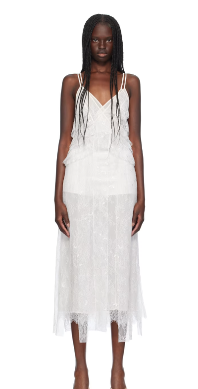 A woman wearing BLUMARINE white ruffled maxi dress