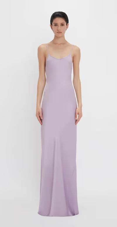 A woman wearing Victoria Beckham purple low back cami floor-length dress in petunia