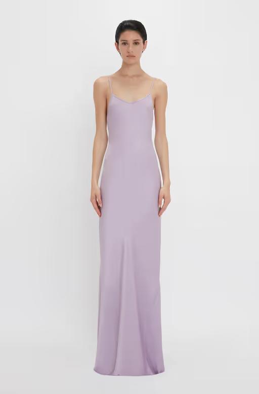 A woman wearing Victoria Beckham purple low back cami floor-length dress in petunia