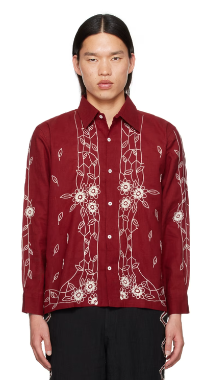 A man wearing Harago burgundy embroidered shirt