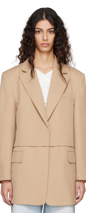 A woman wearing BLOSSOM beige flap blazer