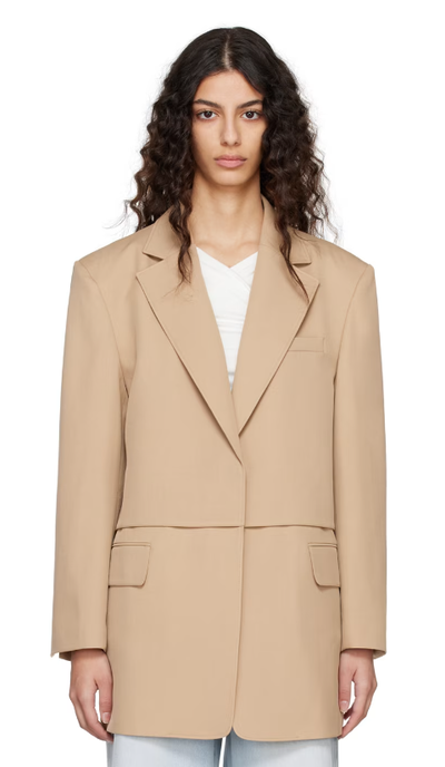 A woman wearing BLOSSOM beige flap blazer