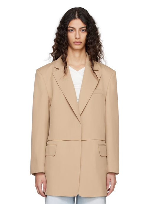 A woman wearing BLOSSOM beige flap blazer