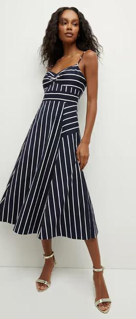 A woman wearing Veronica Beard blige striped dress