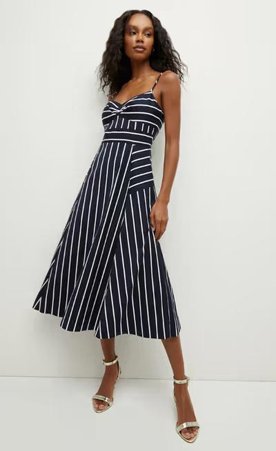 A woman wearing Veronica Beard blige striped dress