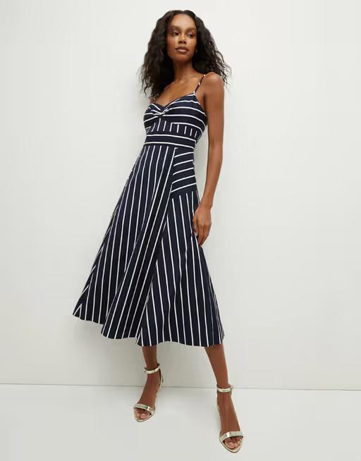 A woman wearing Veronica Beard blige striped dress