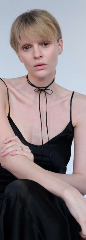 A woman wearing Saskia Diez silk bow choker
