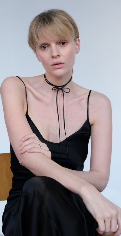A woman wearing Saskia Diez silk bow choker