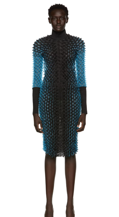A woman wearing CHET LO black & blue evening gown