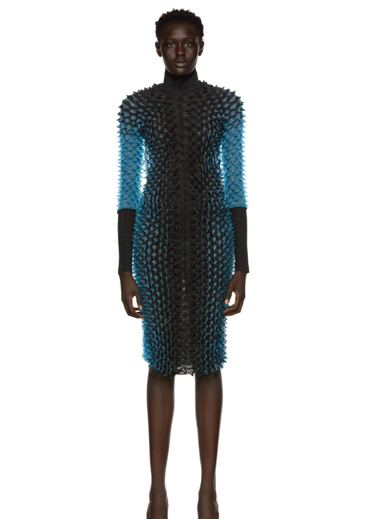 A woman wearing CHET LO black & blue evening gown