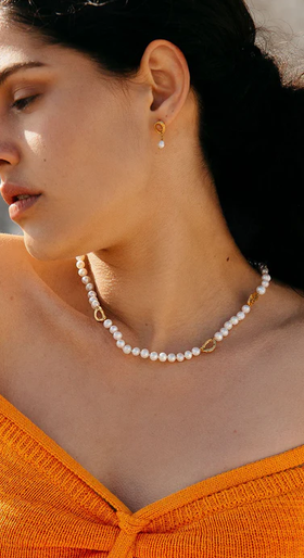 A woman wearing Loveness Lee dio aurum recycled silver earrings